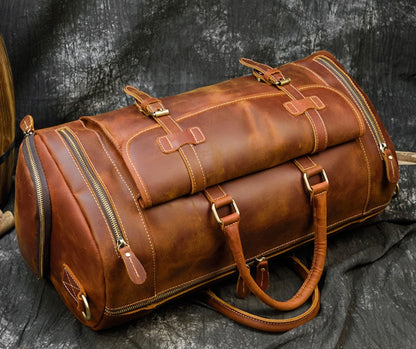 Rugged brown leather duffle bag with multiple buckles and straps, designed for men's travel needs by the brand Bags, Shoes & More.