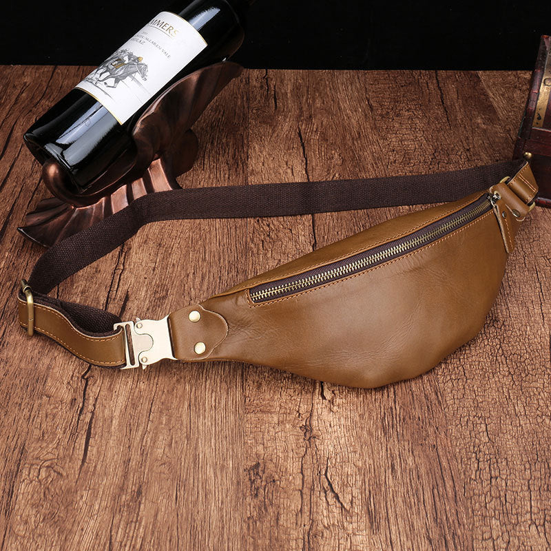 Leather men's cell phone belt bag on a wooden surface with a wine bottle