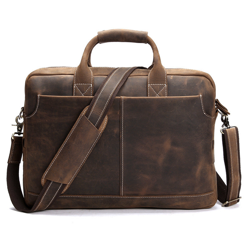 Vintage-inspired leather men's shoulder bag with a rugged, distressed appearance placed on a white background. The bag features a spacious main compartment, multiple exterior pockets, and a detachable shoulder strap for versatile carrying options. The design combines functionality and timeless style, suitable for the modern professional.