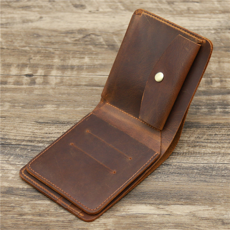 Compact leather wallet with multiple card slots and a minimalist design, resting on a rustic wooden surface.