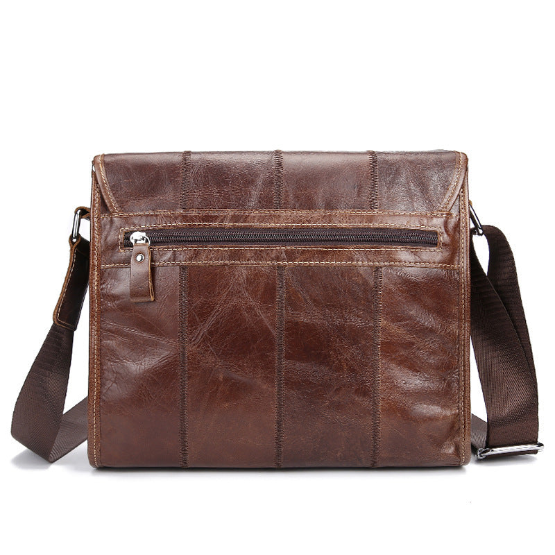 Vintage leather satchel bag in rich brown color with multiple zipped compartments, suitable for casual or professional use.