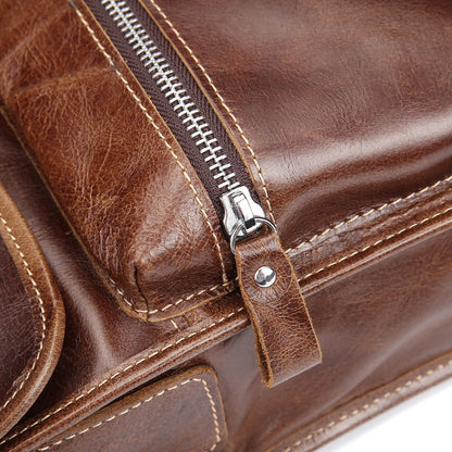 Vintage leather messenger bag with zippers and intricate stitching detail