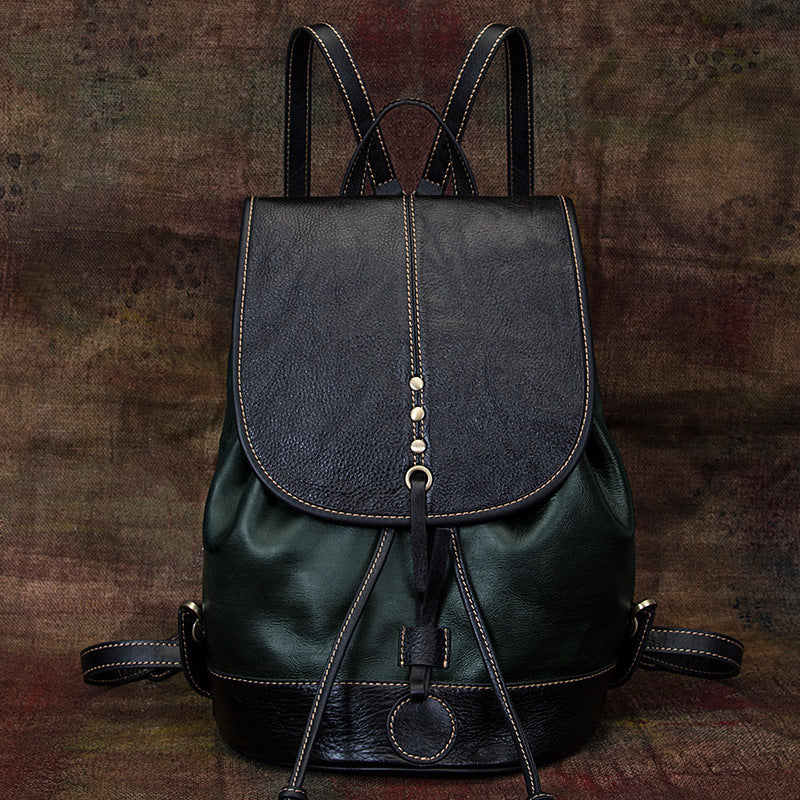 Black Leather Backpack with Drawstring Closure on a Rugged Wood Backdrop