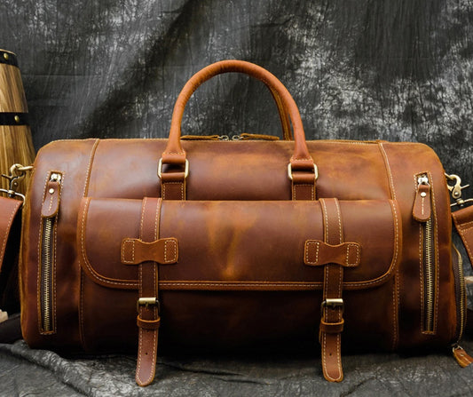 Rustic leather travel bag with a retro design, featuring a cylindrical shape, dual handles, and multiple zipper compartments for storage and organization.