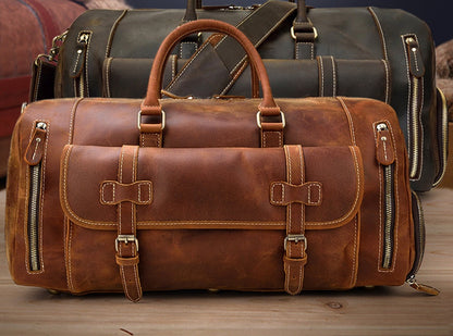 Rugged brown leather travel bag with multiple compartments and straps for convenient carrying.