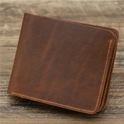 Vintage brown leather wallet with compartments for cards and cash, displayed on a rustic wooden surface.