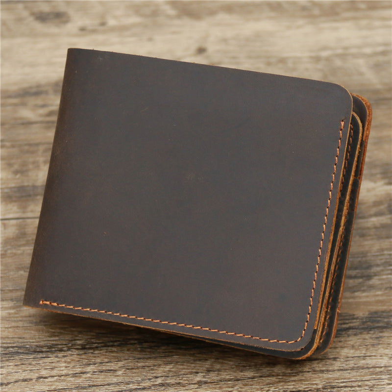 Leather wallet with card slots, classic black design on wooden surface