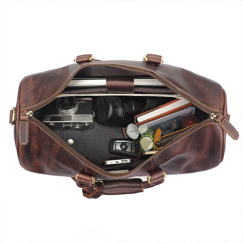 Vintage Distressed Men's Leather Travel Luggage Bag with camera, lens, and photography gear inside the open compartment.