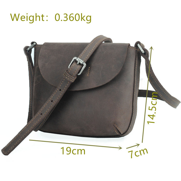 Stylish leather crossbody bag for women, featuring a retro design in a dark gray hue. The bag has a compact square shape, a buckle closure, and an adjustable shoulder strap for convenient everyday carry.